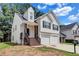 Charming two-story home with a two-car garage and inviting front porch with decorative columns at 2169 Wingfoot Pl, Decatur, GA 30035