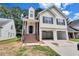 Two-story home features a two-car garage, inviting front entry, and beautiful curb appeal at 2169 Wingfoot Pl, Decatur, GA 30035