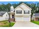 Charming two-story home boasts a two-car garage, inviting staircase, and neatly maintained front yard at 2169 Wingfoot Pl, Decatur, GA 30035