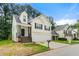 Charming two-story home boasts an attached two-car garage, and a stairway leading up to the front door at 2169 Wingfoot Pl, Decatur, GA 30035