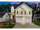 Charming two-story home boasts a two-car garage, inviting staircase, and neatly maintained front yard at 2169 Wingfoot Pl, Decatur, GA 30035