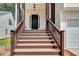 Exterior of front entrance showing wooden stairs, dark door, and garage at 2169 Wingfoot Pl, Decatur, GA 30035