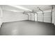 Spacious three car garage with gray painted floors, lots of room for storage and work space at 2169 Wingfoot Pl, Decatur, GA 30035
