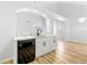 Bright living room with modern light fixtures, light wood floors, and marble countertop wet bar area at 2169 Wingfoot Pl, Decatur, GA 30035