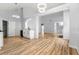 Bright living room with modern light fixtures, light wood floors, and marble countertop wet bar area at 2169 Wingfoot Pl, Decatur, GA 30035