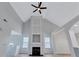 Bright living room features a soaring ceiling, modern ceiling fan, fireplace, and natural light at 2169 Wingfoot Pl, Decatur, GA 30035