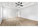 Spacious primary bedroom featuring neutral carpet, a ceiling fan, and an ensuite bathroom at 2169 Wingfoot Pl, Decatur, GA 30035