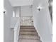 Carpeted staircase with white railing and trim, offering a bright and open transition between floors at 2169 Wingfoot Pl, Decatur, GA 30035