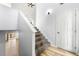 Bright stairway featuring hardwood floors, a door, and plush carpeting on the stairs at 2169 Wingfoot Pl, Decatur, GA 30035