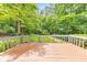 View from wood deck overlooking lush, landscaped backyard at 405 W Leslie Ct, Woodstock, GA 30188