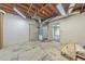 Unfinished basement area with painted walls, utility fixtures, and doorway to finished living space at 405 W Leslie Ct, Woodstock, GA 30188