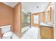 Well-lit bathroom with a glass-enclosed shower and dual sink vanity at 405 W Leslie Ct, Woodstock, GA 30188