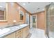 Bathroom with double sinks, a walk-in shower, and white tiled flooring at 405 W Leslie Ct, Woodstock, GA 30188