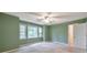 Bedroom with neutral carpet, ceiling fan, and three windows at 405 W Leslie Ct, Woodstock, GA 30188