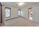 Bright bedroom features neutral carpet, two windows, and white trim at 405 W Leslie Ct, Woodstock, GA 30188