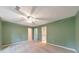 Bedroom with neutral carpet, ceiling fan, and view of closet at 405 W Leslie Ct, Woodstock, GA 30188