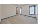 Light-filled bedroom with neutral carpet, a window, and an adjacent closet at 405 W Leslie Ct, Woodstock, GA 30188