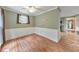Cozy dining room area with wood-look floors, wainscotting, and plenty of natural light at 405 W Leslie Ct, Woodstock, GA 30188