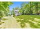 Two-story house with a spacious front lawn surrounded by trees at 405 W Leslie Ct, Woodstock, GA 30188