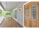 Inviting front porch boasts a beautiful wood door and ample space for relaxing at 405 W Leslie Ct, Woodstock, GA 30188