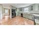 Bright kitchen boasts granite countertops and plentiful cabinet space with an open layout at 405 W Leslie Ct, Woodstock, GA 30188