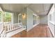 Relax on the spacious porch with a swing and views of the lush surroundings at 405 W Leslie Ct, Woodstock, GA 30188