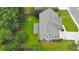 Aerial view showcases home with well-maintained lawn, garden, trees, and a backyard fire pit at 456 Rockford Sw Pass, Marietta, GA 30064