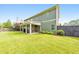 Spacious backyard featuring a lush lawn, a covered patio, mature trees, and a private fence at 456 Rockford Sw Pass, Marietta, GA 30064