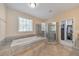Large bathroom suite with soaking tub, glass enclosed shower, and tile floors at 456 Rockford Sw Pass, Marietta, GA 30064