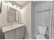 Well-lit bathroom with a large mirror over a marble vanity with ample storage, and a toilet with shower curtain at 456 Rockford Sw Pass, Marietta, GA 30064