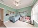 Inviting bedroom with a cozy loveseat, natural light, and sports-themed decor at 456 Rockford Sw Pass, Marietta, GA 30064