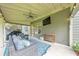 Relaxing covered patio features a ceiling fan, an outdoor TV, a grilling area, and a seating area at 456 Rockford Sw Pass, Marietta, GA 30064