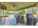 Cozy covered patio featuring comfortable seating, a ceiling fan, and a grill, perfect for outdoor entertaining at 456 Rockford Sw Pass, Marietta, GA 30064