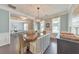 Open-concept dining room with a wooden table, stylish lighting, and views into the home office at 456 Rockford Sw Pass, Marietta, GA 30064
