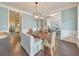 Bright dining room with a wooden table, wicker chairs, open to other living areas, and light blue walls at 456 Rockford Sw Pass, Marietta, GA 30064