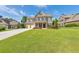 Charming two-story home with lush green lawn, three-car garage and a basketball hoop on the driveway at 456 Rockford Sw Pass, Marietta, GA 30064
