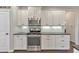Modern kitchen with stainless steel appliances, white cabinetry and subway tile backsplash at 456 Rockford Sw Pass, Marietta, GA 30064