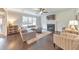 Cozy living room with a fireplace, hardwood floors, a comfortable couch, and a ceiling fan at 456 Rockford Sw Pass, Marietta, GA 30064