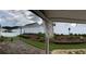 Landscaped backyard with brick patio, white fence, terraced planting beds, and a grassy area at 804 Village Pl, Loganville, GA 30052