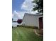 Beautiful backyard features green grass, landscaping, and privacy fence at 804 Village Pl, Loganville, GA 30052