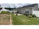 A well-maintained backyard features a manicured lawn, patio, privacy fence, and mature landscaping at 804 Village Pl, Loganville, GA 30052