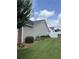 Beautiful backyard features green grass, landscaping, and vinyl privacy fence at 804 Village Pl, Loganville, GA 30052
