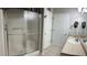 Bathroom featuring a glass-enclosed shower, vanity, and neutral tile flooring at 804 Village Pl, Loganville, GA 30052