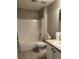 Clean bathroom with a shower-tub combo, white cabinets, neutral tile flooring, and standard toilet at 804 Village Pl, Loganville, GA 30052