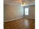 Bedroom with a ceiling fan, wood floors, neutral paint, and natural light at 804 Village Pl, Loganville, GA 30052