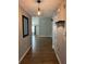 Inviting entryway featuring wood-look flooring and modern light fixtures with a view into the living space at 804 Village Pl, Loganville, GA 30052