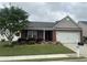 Charming single-story brick home featuring a well-manicured lawn, a two-car garage, and lovely front yard landscaping at 804 Village Pl, Loganville, GA 30052