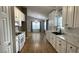 Bright kitchen with white cabinets, marble countertops, and stainless steel appliances at 804 Village Pl, Loganville, GA 30052