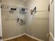 Small laundry room with white shelving and room for a washer and dryer at 804 Village Pl, Loganville, GA 30052