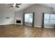 Open living room featuring wood floors, fireplace, and lots of natural light at 804 Village Pl, Loganville, GA 30052